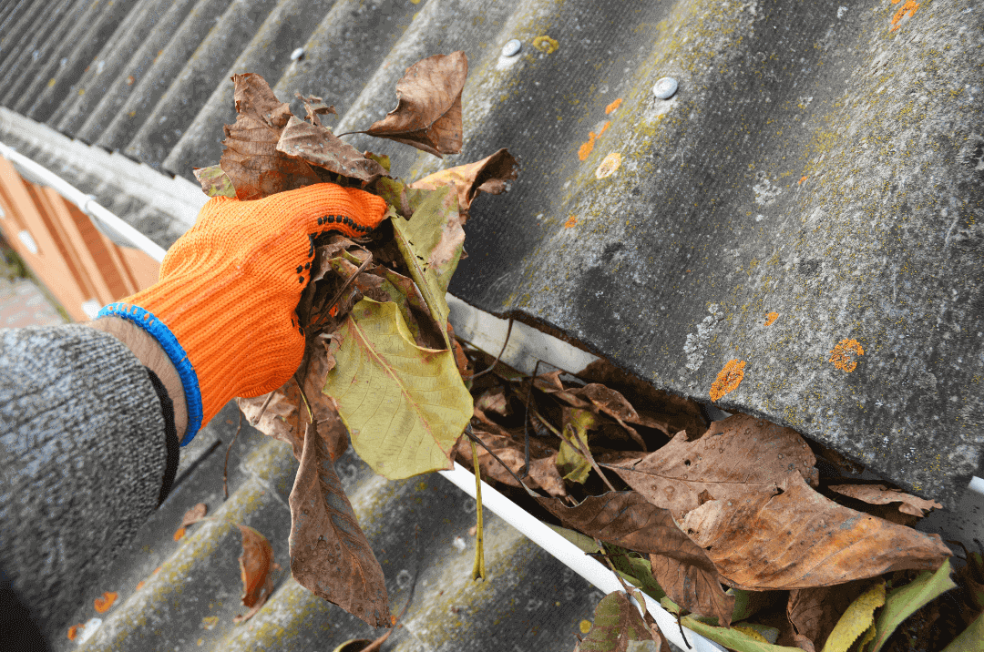 Clearing the clogged Gutters to prepare for the rainy season