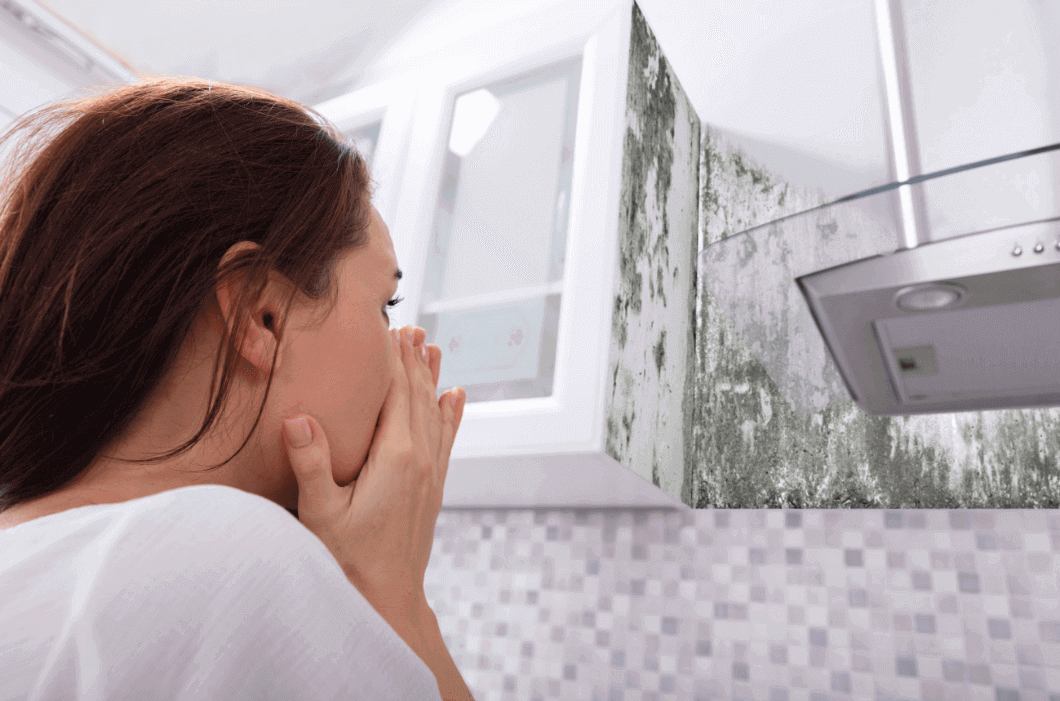 Woman Looking At Mold On Wall 